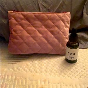 Brightening facial serum with makeup bag